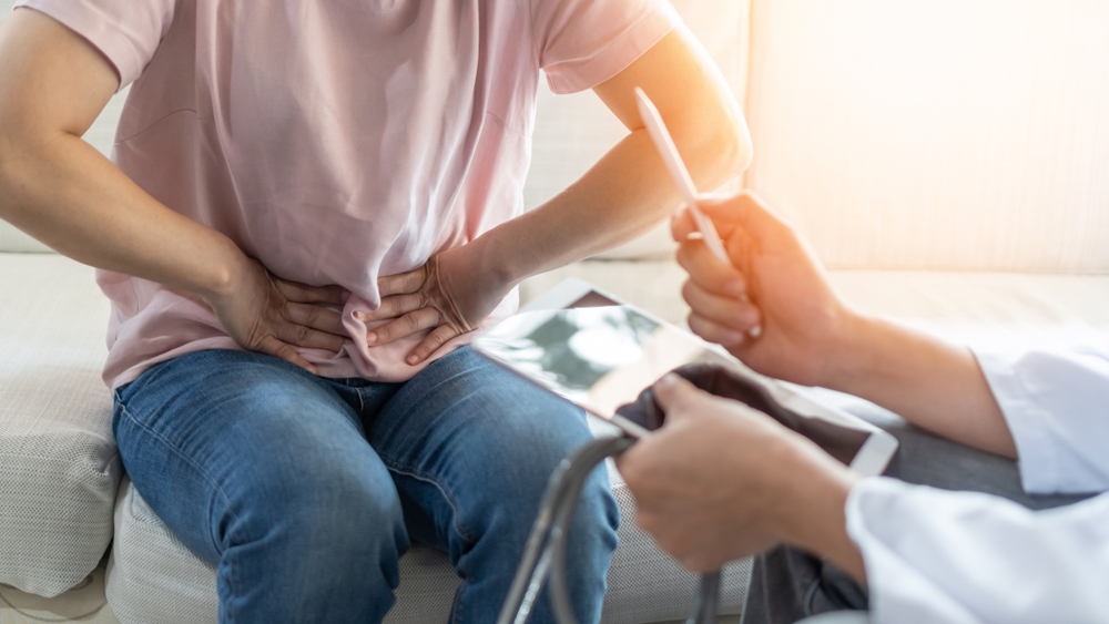 Abdominal,pain,patient,woman,having,medical,exam,with,doctor,on